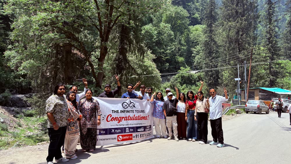 A group with The Infinite Tours banner