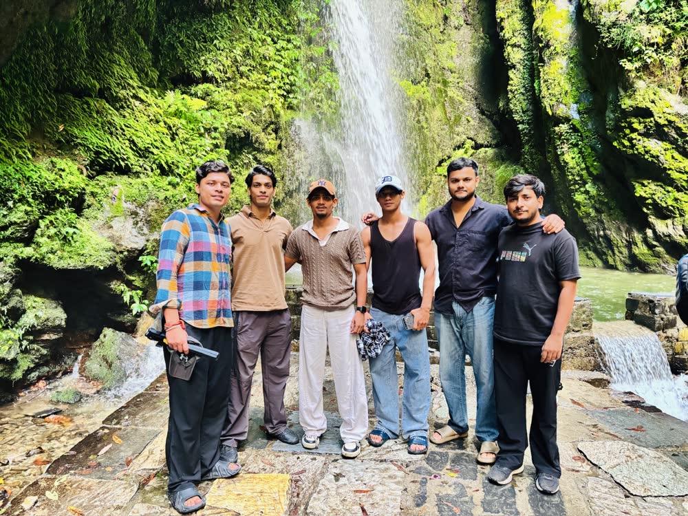 Friends at a waterfall in Jibhi